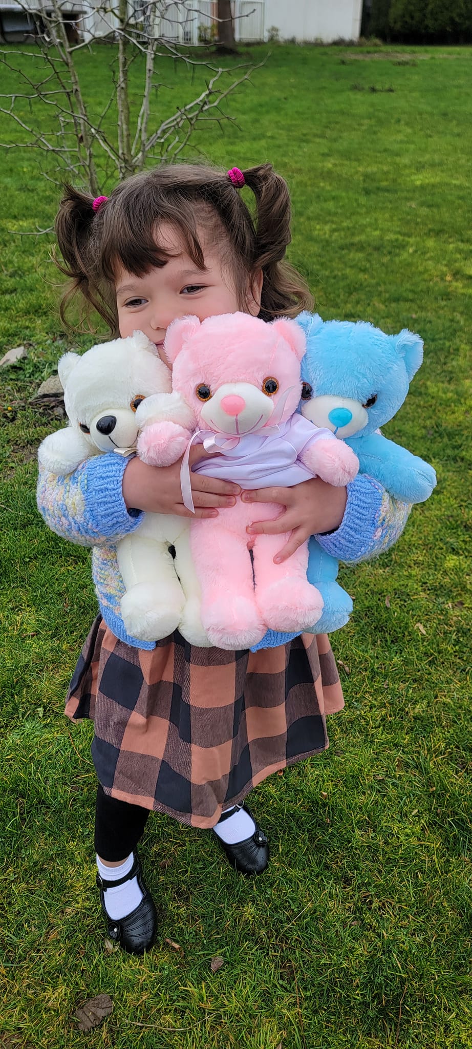 Child holding illuminated white LED teddy bear with shirt