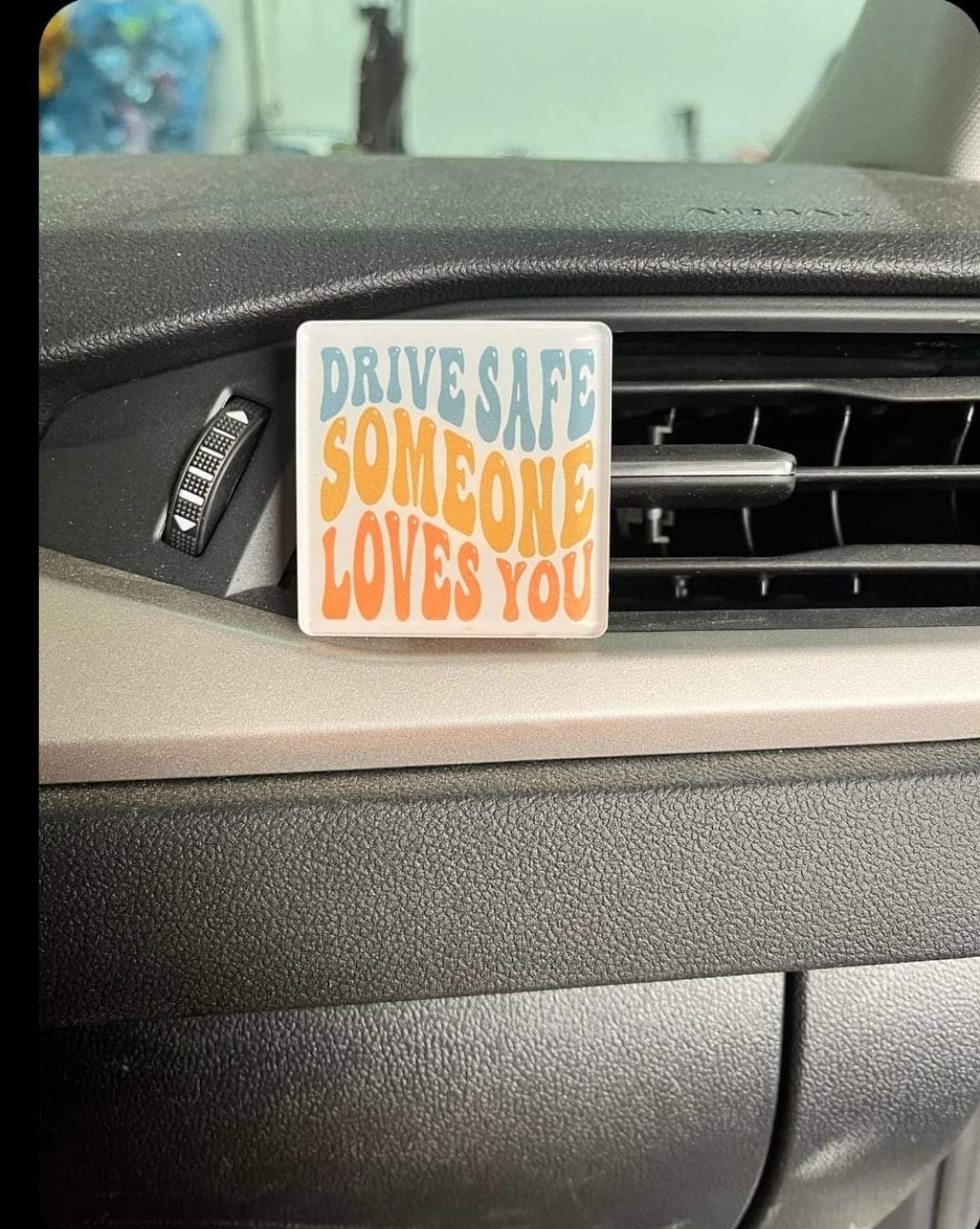 Square finished vent-clip example attached to a car air vent