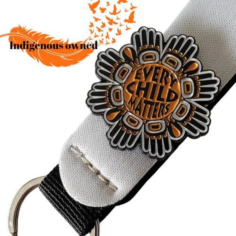 Every Child Matters black-and-orange metal badge front view