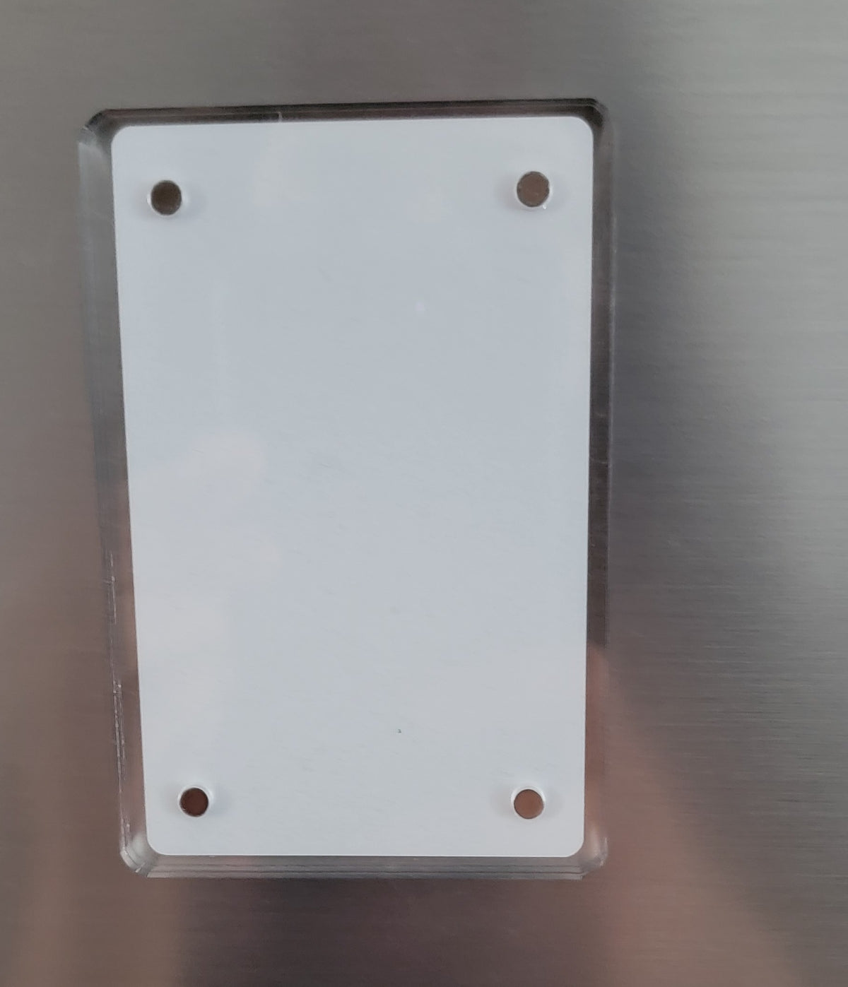 Clear acrylic photo-magnet frame with white insert and four corner magnets