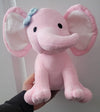 Pink elephant plush held from the front with white inner-ear panels